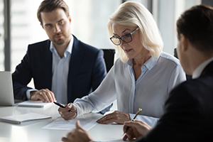 business people planning at a table following the presentation of a senior member