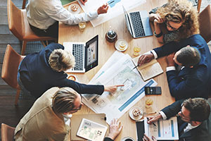 contract agents reviewing plans in a meeting