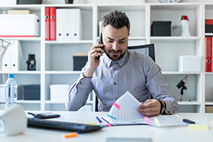 lawyer speaking on the phone at their office desk