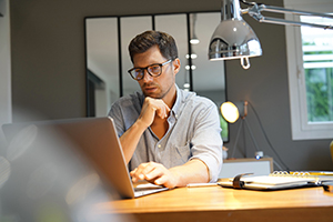 small business owner working on a laptop in their office